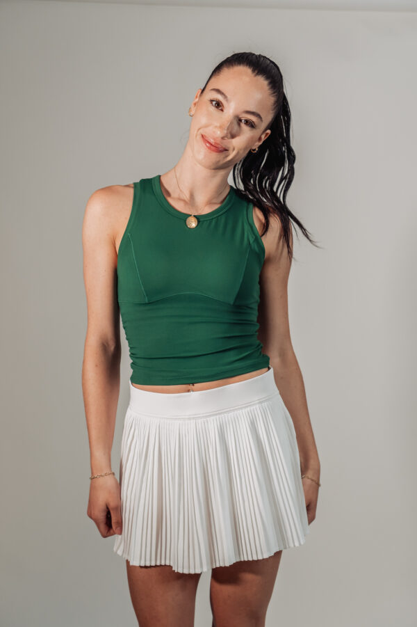Model Nikki wearing green Good Dink sleeveless top and white pleated Good Dink skort